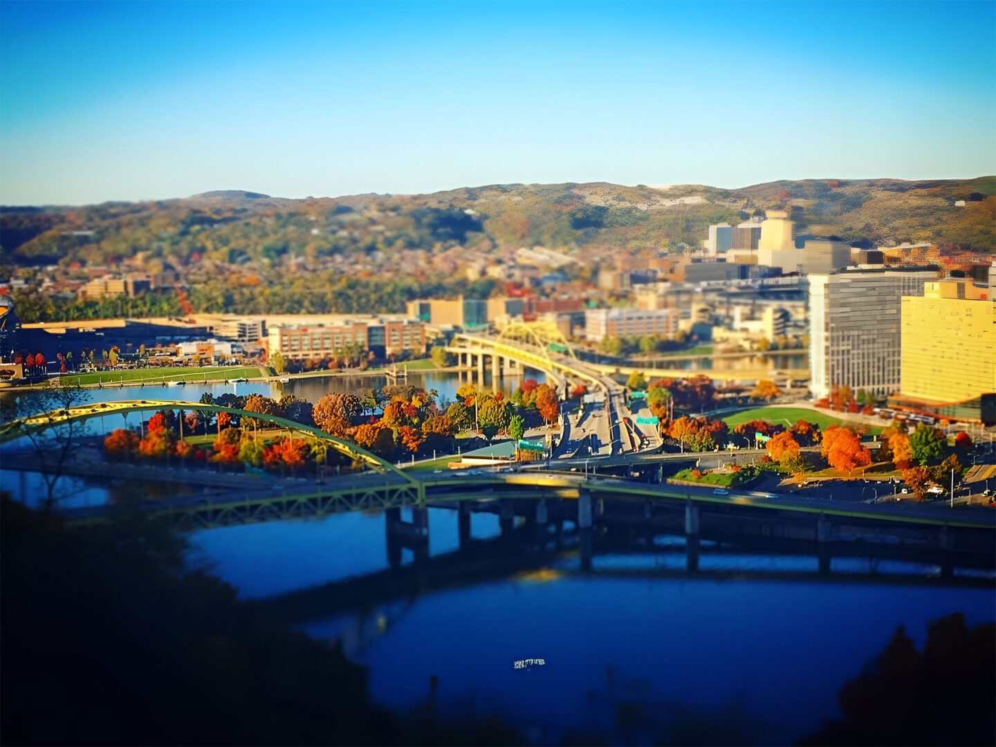 A view of the city from above with trees in autumn colors.